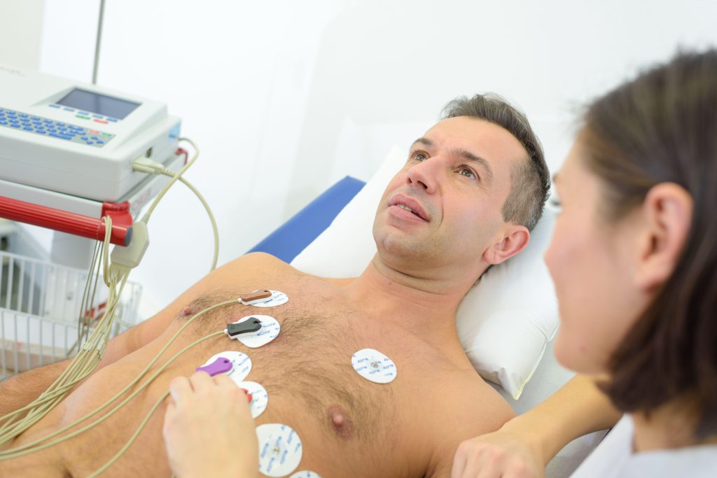 Man undergoing an ECG/EKG test before surgery